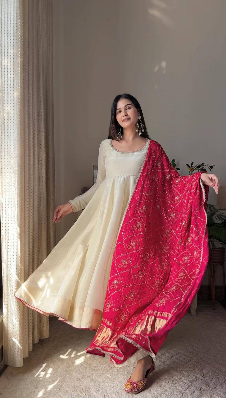 Add elegance to your festive look with this Exclusive 3 Piece Gown Pair crafted in luxurious Chinon fabric. Adorned with golden lace and fine piping
