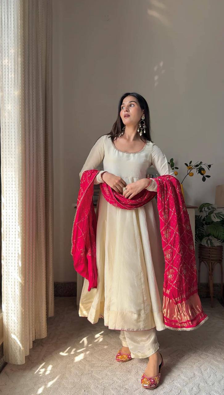 Add elegance to your festive look with this Exclusive 3 Piece Gown Pair crafted in luxurious Chinon fabric. Adorned with golden lace and fine piping