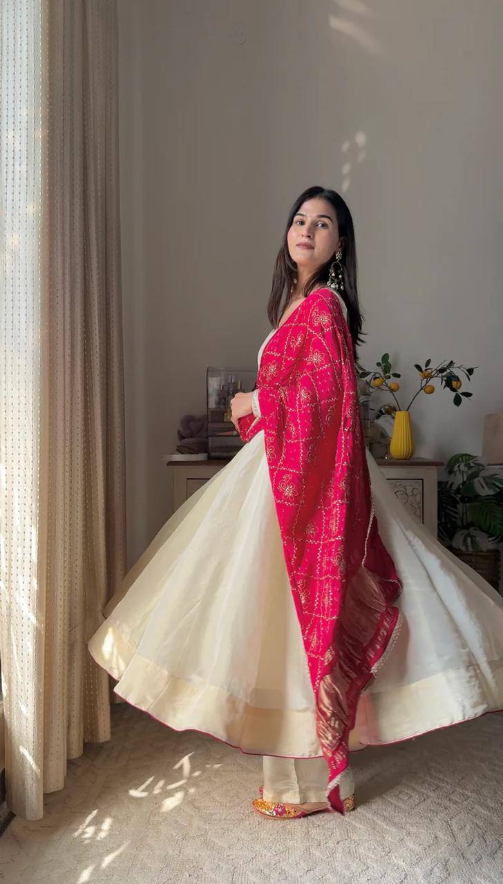 Add elegance to your festive look with this Exclusive 3 Piece Gown Pair crafted in luxurious Chinon fabric. Adorned with golden lace and fine piping