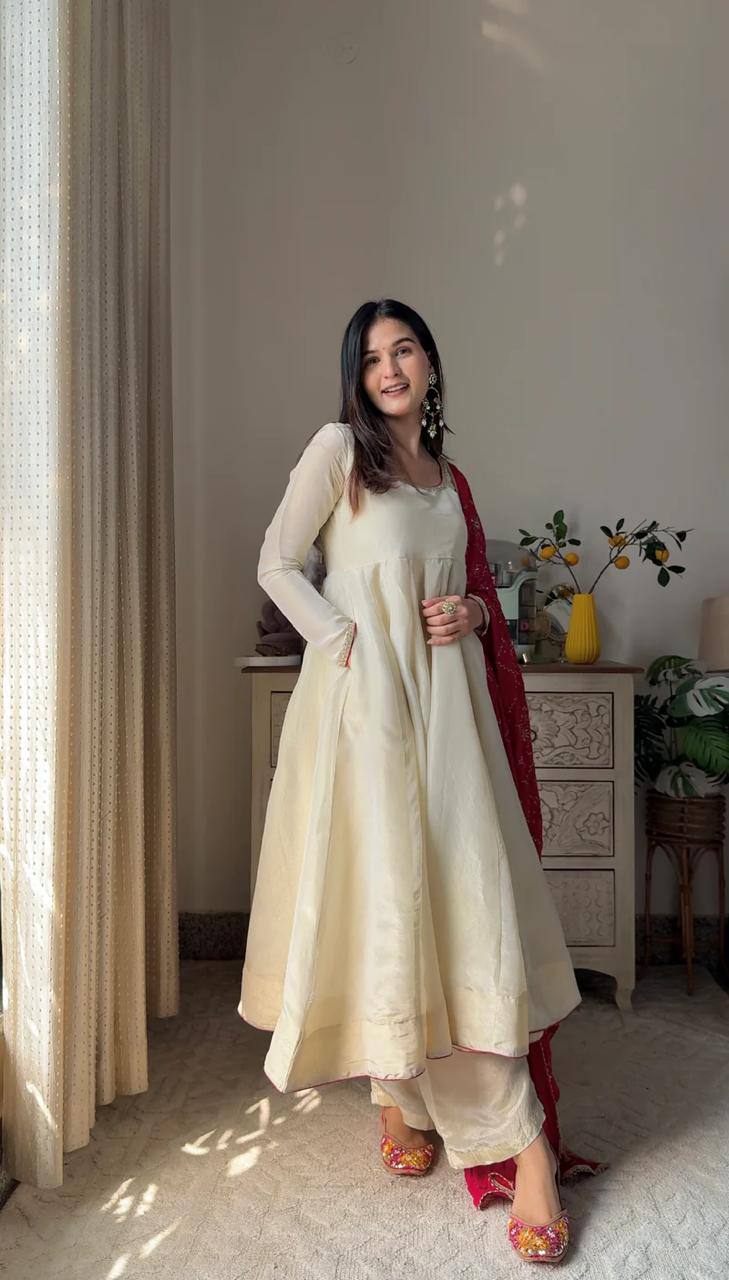 Add elegance to your festive look with this Exclusive 3 Piece Gown Pair crafted in luxurious Chinon fabric. Adorned with golden lace and fine piping
